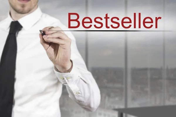 Businessman writing bestseller in the air — Stock Photo, Image