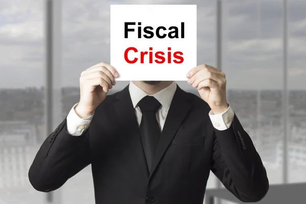 Businessman hiding face behind sign fiscal crisis — Stock Photo, Image