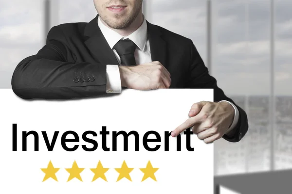 Businessman pointing on sign investment golden stars — Stock Photo, Image