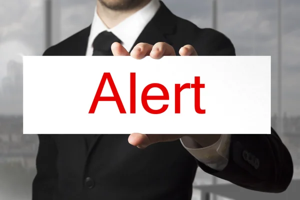 Businessman holding sign alert — Stock Photo, Image