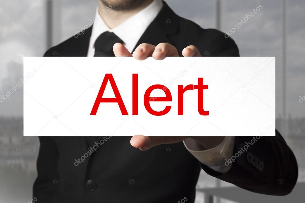 businessman holding sign alert