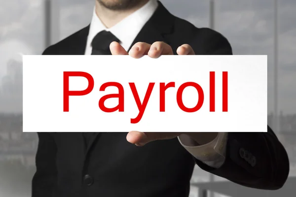 Businessman holding sign payroll — Stock Photo, Image