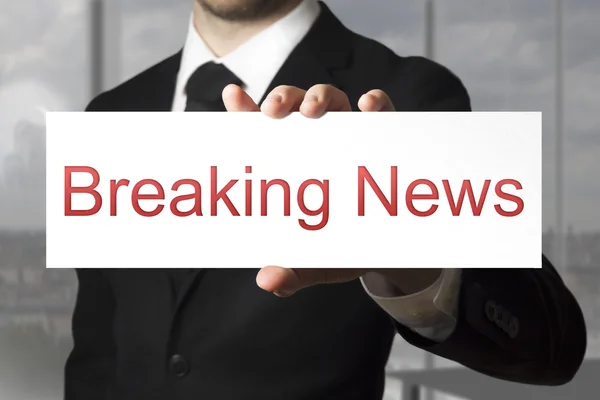 Businessman holding sign breaking news — Stock Photo, Image