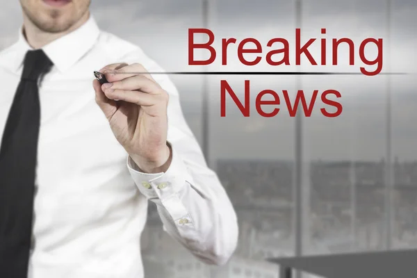 Businessman writing breaking news in the air — Stock Photo, Image