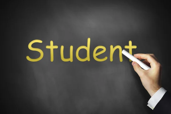 Hand writing student on black chalkboard — Stock Photo, Image