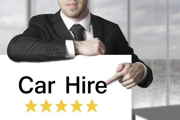 Businessman pointing on sign car hire — Stock Photo, Image