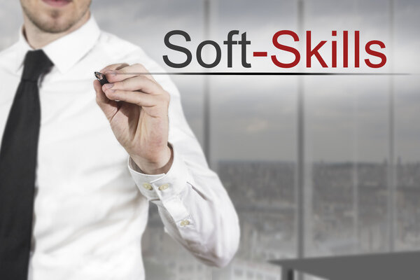 businessman writing soft skills in the air