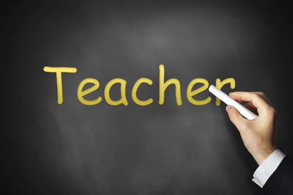 Hand writing teacher on black chalkboard — Stock Photo, Image