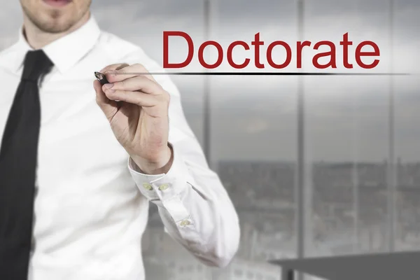 Businessman writing doctorate in the air — Stock Photo, Image