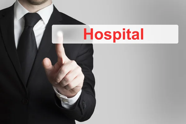 Businessman pushing flat button hospital — Stock Photo, Image