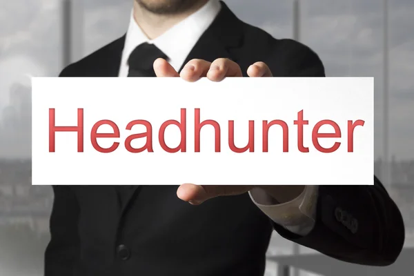 Uomo d'affari in possesso di bianco segno headhunter — Foto Stock