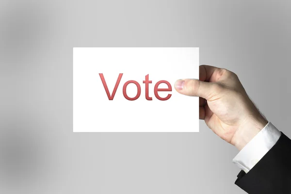 Рука тримає картку голосування — стокове фото