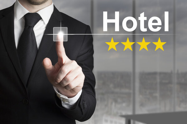 Businessman pushing button hotel four star rating