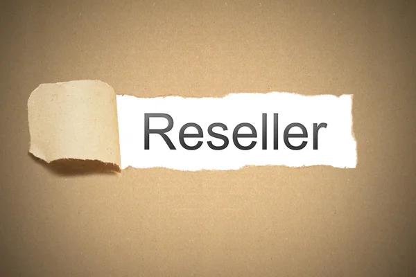 Brown paper torn to reveal reseller — Stock Photo, Image