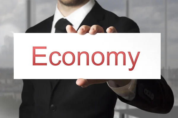 Businessman showing sign economy — Stock Photo, Image