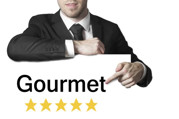 Empresário apontando em sinal gourmet cinco estrelas — Fotografia de Stock
