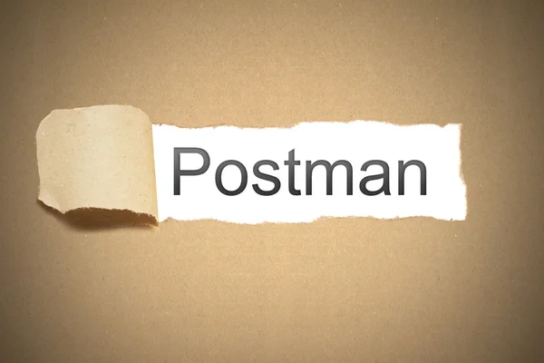 Brown paper torn to reveal postman — Stock Photo, Image