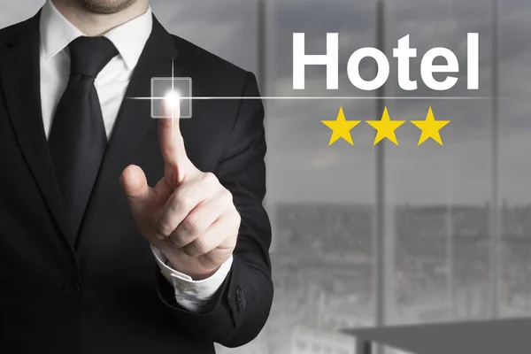 Businessman pushing button hotel three stars — Stock Photo, Image