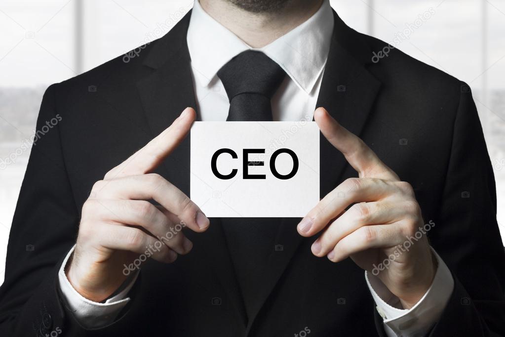 Businessman holding small white sign ceo