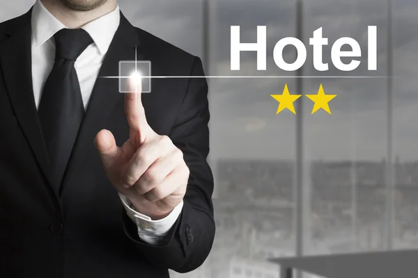 Businessman pushing button hotel two stars — Stock Photo, Image