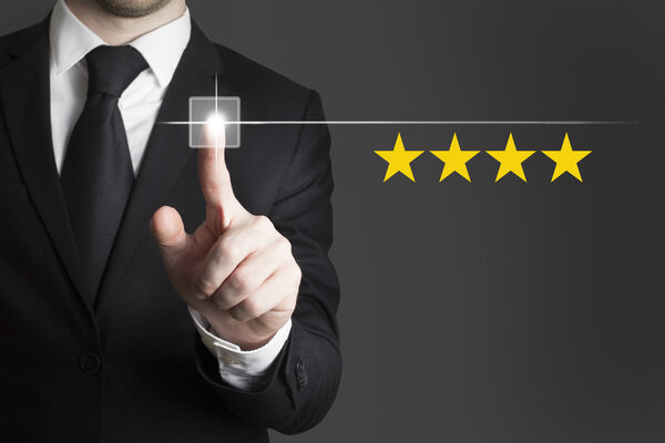 businessman pushing button four star rating