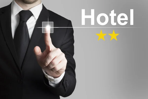 Businessman pushing button hotel two stars — Stock Photo, Image