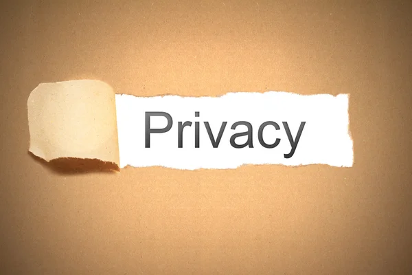 Brown packaging paper torn to reveal privacy — Stock Photo, Image