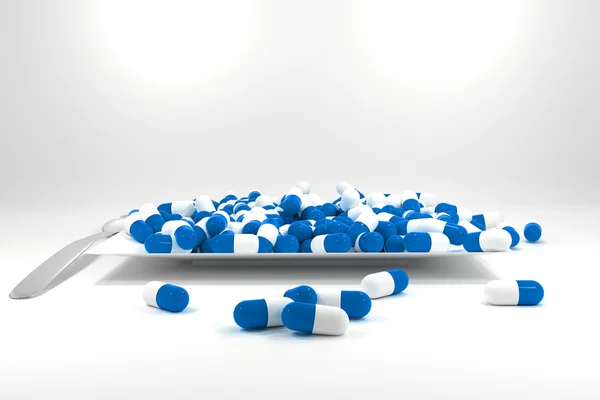 Grande pilha de comprimidos de cor azul na placa branca — Fotografia de Stock