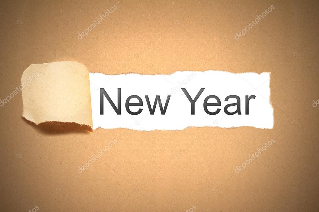 brown paper torn to reveal new year