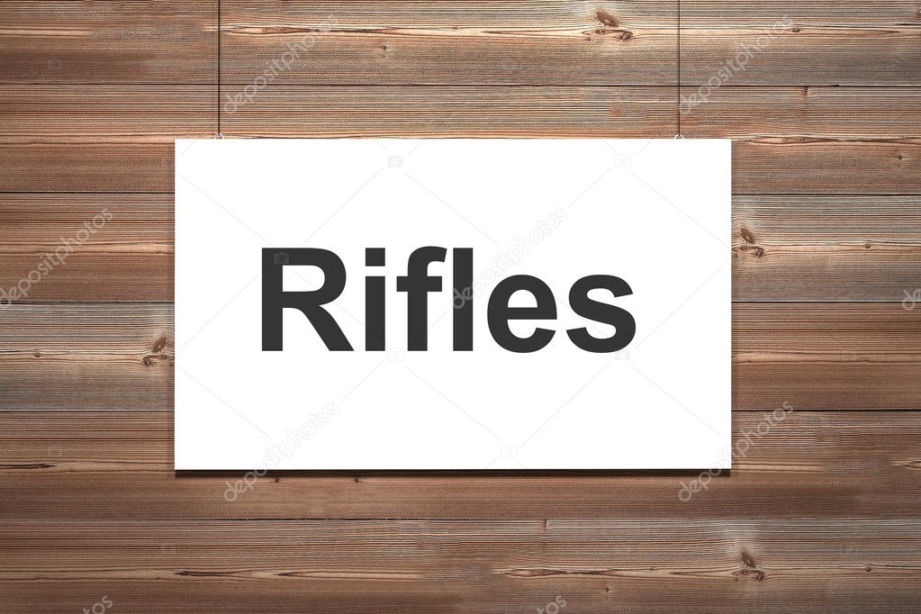 white canvas hanging on natural brown wooden wall rifles