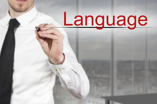 Hombre de negocios escribiendo lenguaje en el aire — Foto de Stock