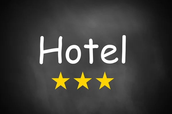 Hand writing hotel on black chalkboard three stars — Stock Photo, Image