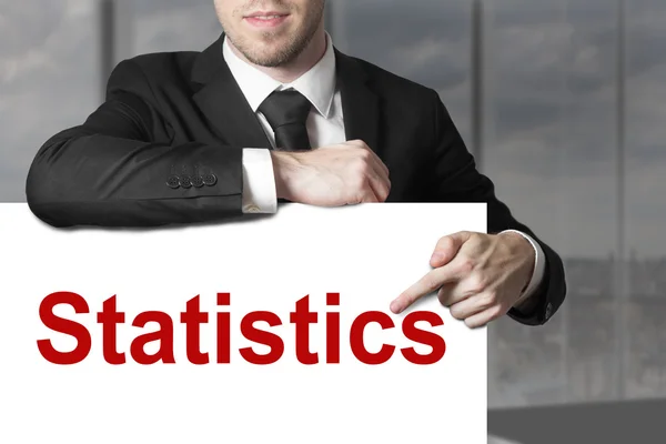 Podnikatel, ukazující na znamení statistiky — Stock fotografie