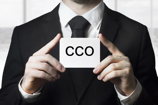 Biznesmen posiadania cco mały biały znak — Zdjęcie stockowe
