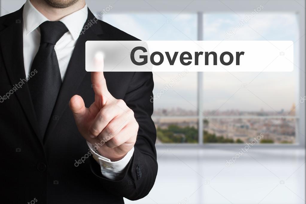 businessman in office pushing button governor