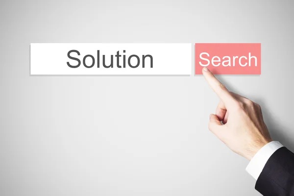 Businessmans finger pushing search button solution — Stock Photo, Image