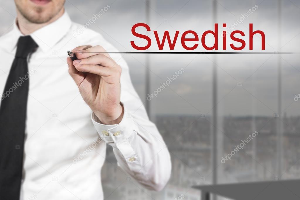 businessman in office writing swedish in the air 