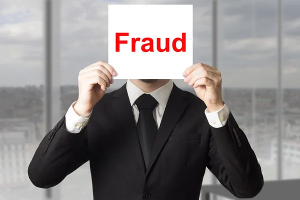 Businessman hiding face behind sign fraud — Stock Photo, Image