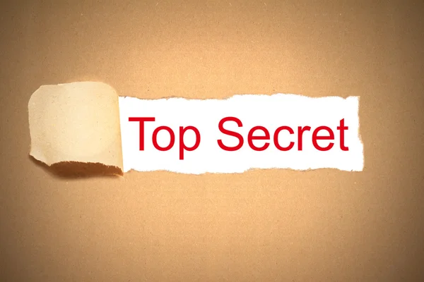 Brown paper torn to reveal top secret — Stock Photo, Image