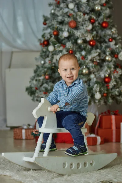Small Cute Boy Smiles Sitting White Wooden Rocking Horse Background Stock Image