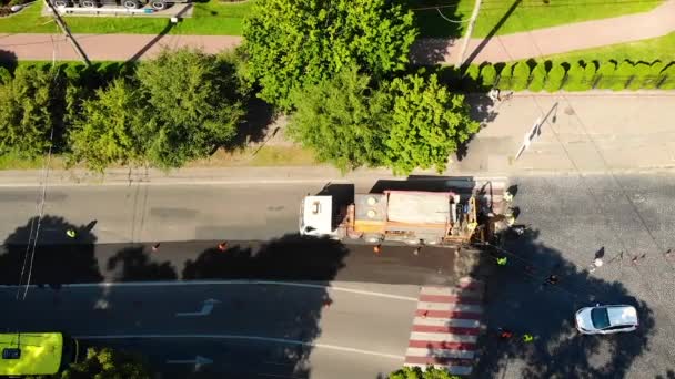 Road repair. Flight of a drone. The car for laying of an asphalt. Traffic jams — Stock Video