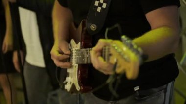 Müzisyenlerin çaldığı el ve gitarın portresi