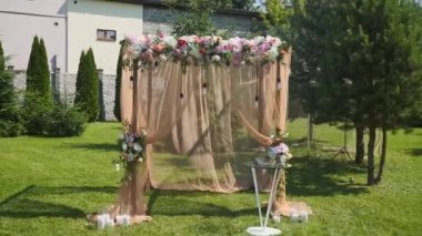 Düğün dekoru. Güzel bir düğün kemeri. Bahçede taze çiçekler var. Güneşli bir yaz gününde.