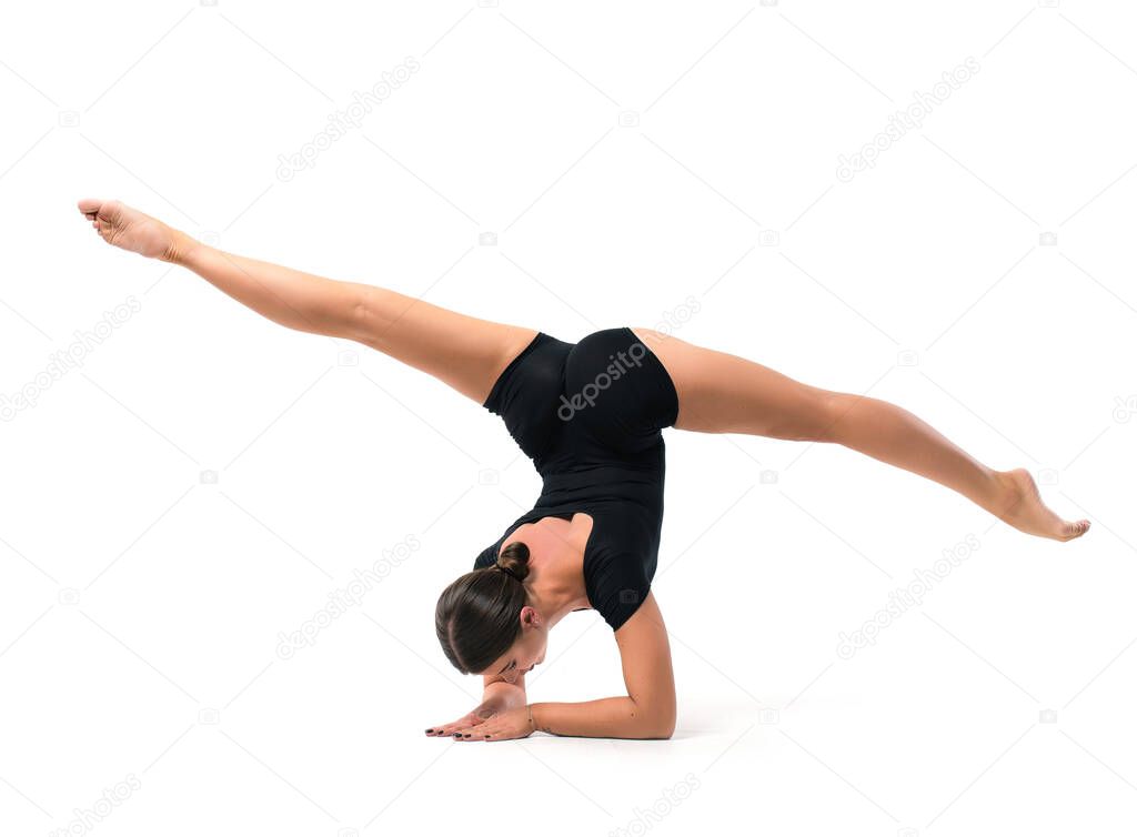 Beautiful athletic young woman in sportswear, training, element of gymnastics, performs exercises on a white background. Sports motivation, stretching, coach, physical education