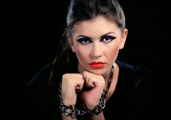Fashion portrait of an attractive woman with colorful makeup and red lipstick.