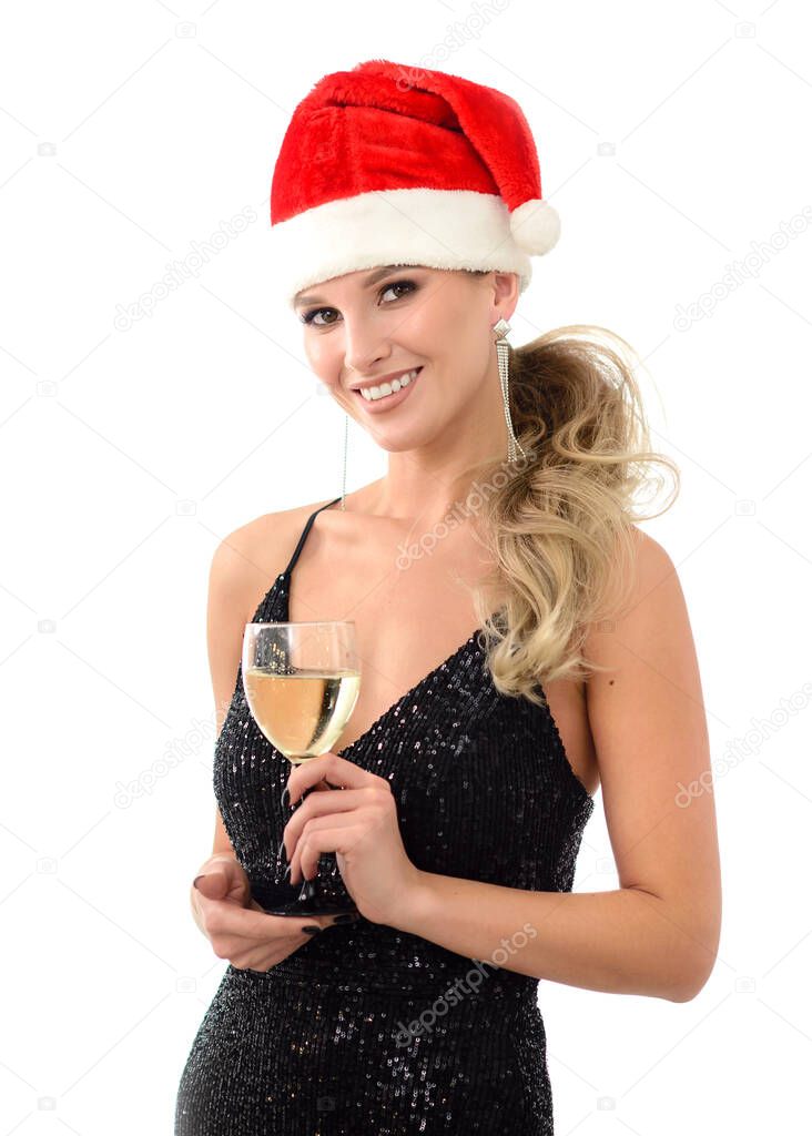 Smiling christmas woman in a santa hat with a beautiful white smile with a glass of wine. Happy people, the concept of new year greetings