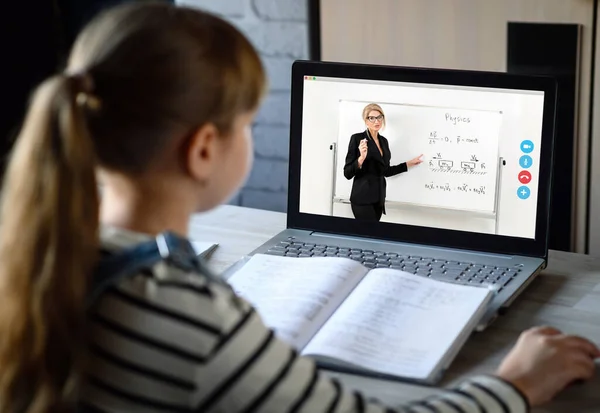 Schoolgirl and teacher learn a physics lesson using a video chat on computer. Video conference with the tutor at home. Online distance education