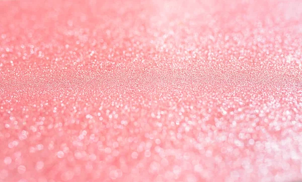 Pink blurred background with highlights. Fine texture of shiny crystals