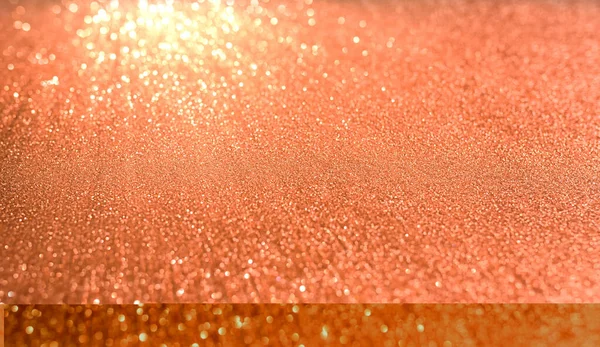 Orange blurred background with highlights. Fine texture of shiny crystals