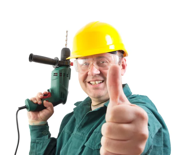 Reparador sonriente con un taladro gesto pulgares hacia arriba, recorte camino incluido — Foto de Stock